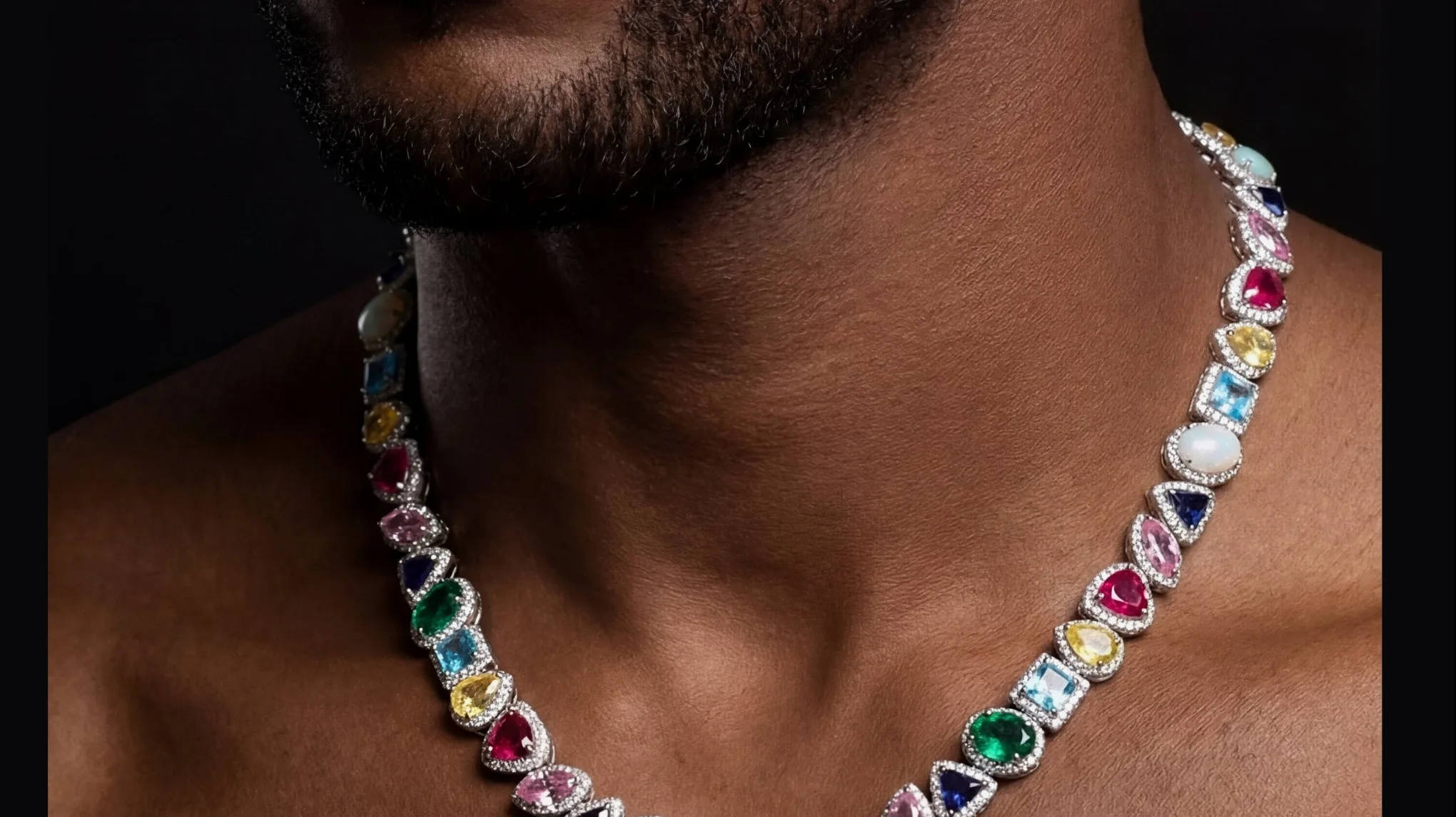 A client wearing a Royal T multicolor gemstone necklace set in solid gold with a halo of natural diamonds