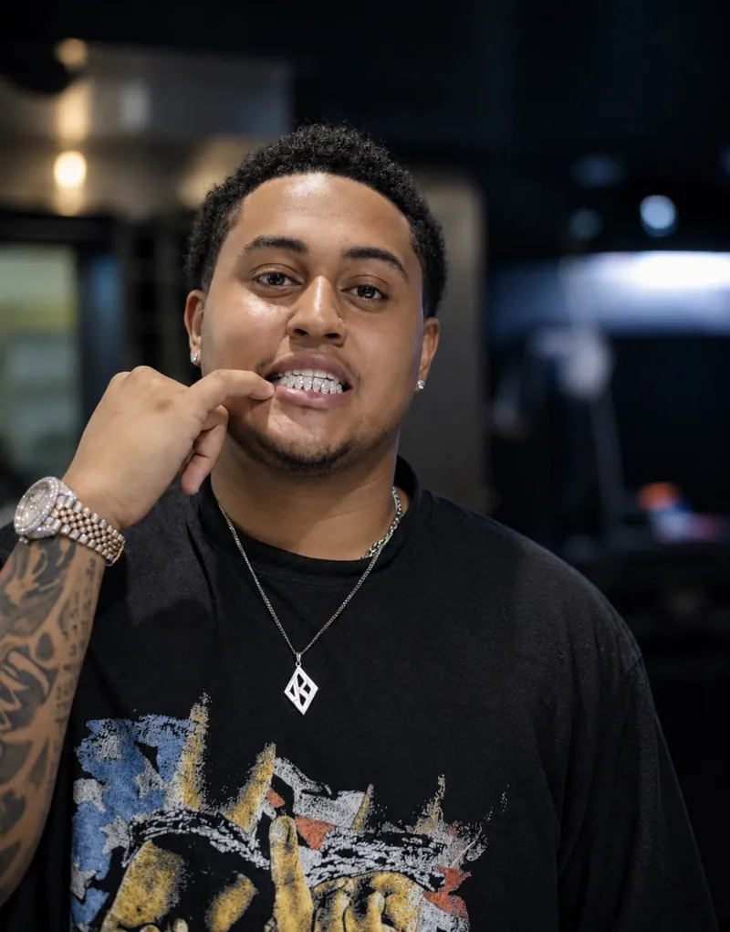 A client pointing to his custom grillz